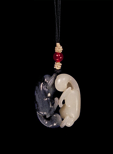 Reverse: Nephrite pendant, mutton fat white with dark grey areas cleverly carved with two cats playing, the two cats carved precisely from the two colours.