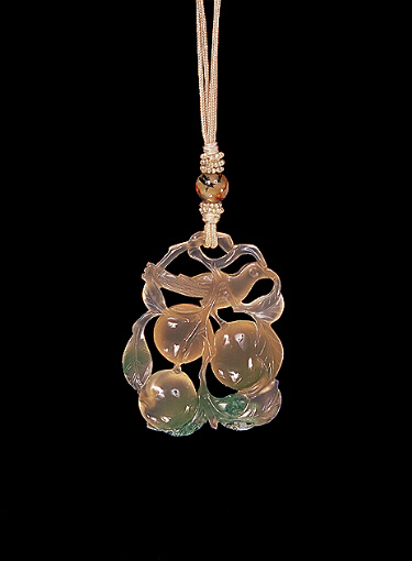Reverse: Chalcedony pendant, pale, translucent grey agate with a green chlorite skin, the grey colour carved with peaches and leaves and a bird, the green carved with leaves, small insects and a frog.