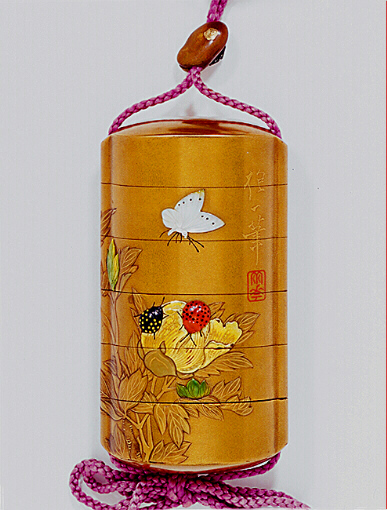 Close-Up Reverse: Flowers and insects inro with a metal ojime of a fly on a bean.